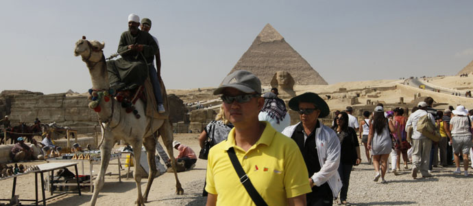 Tourists visit the Pyramids of Giza in Cairo